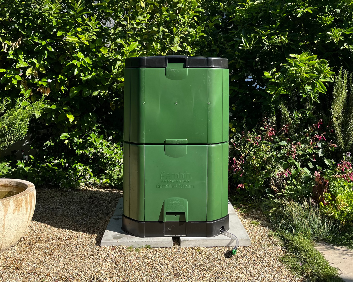 400L Aerobin Home Composter, neatly set up in a home garden